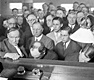Clarence Darrow would enter a surprise plea of "guilty" for the killers. Here, he is shown (far left) with Nathan Leopold (center right) and Richard Loeb (center, behind Leopold) in the courtroom during arraignment.