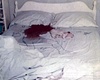 Blood stains, urine stain, pink knitted collar and body outline of Kimberley MacDonald on bottom sheet in south bedroom